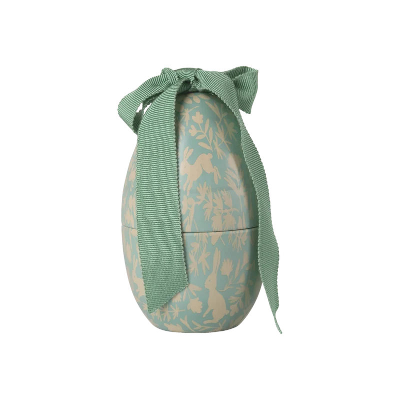 Pequena caixa de metal em forma de ovo com estampado de menta